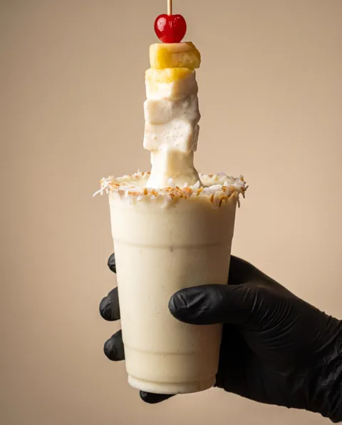 A creamy horchata drink with a coconut rim