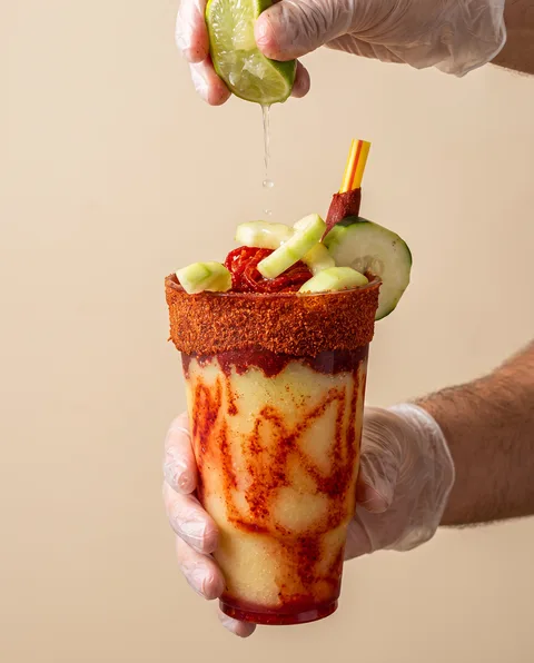 A glossy red chamoy apple with fresh fruit