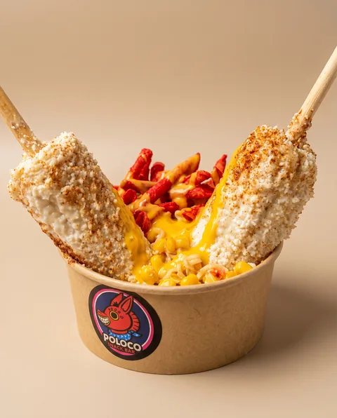A grilled Maru-Elote with lime, chili and dipping sauces